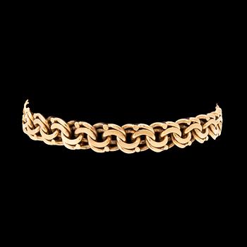 An 18K gold bracelet.