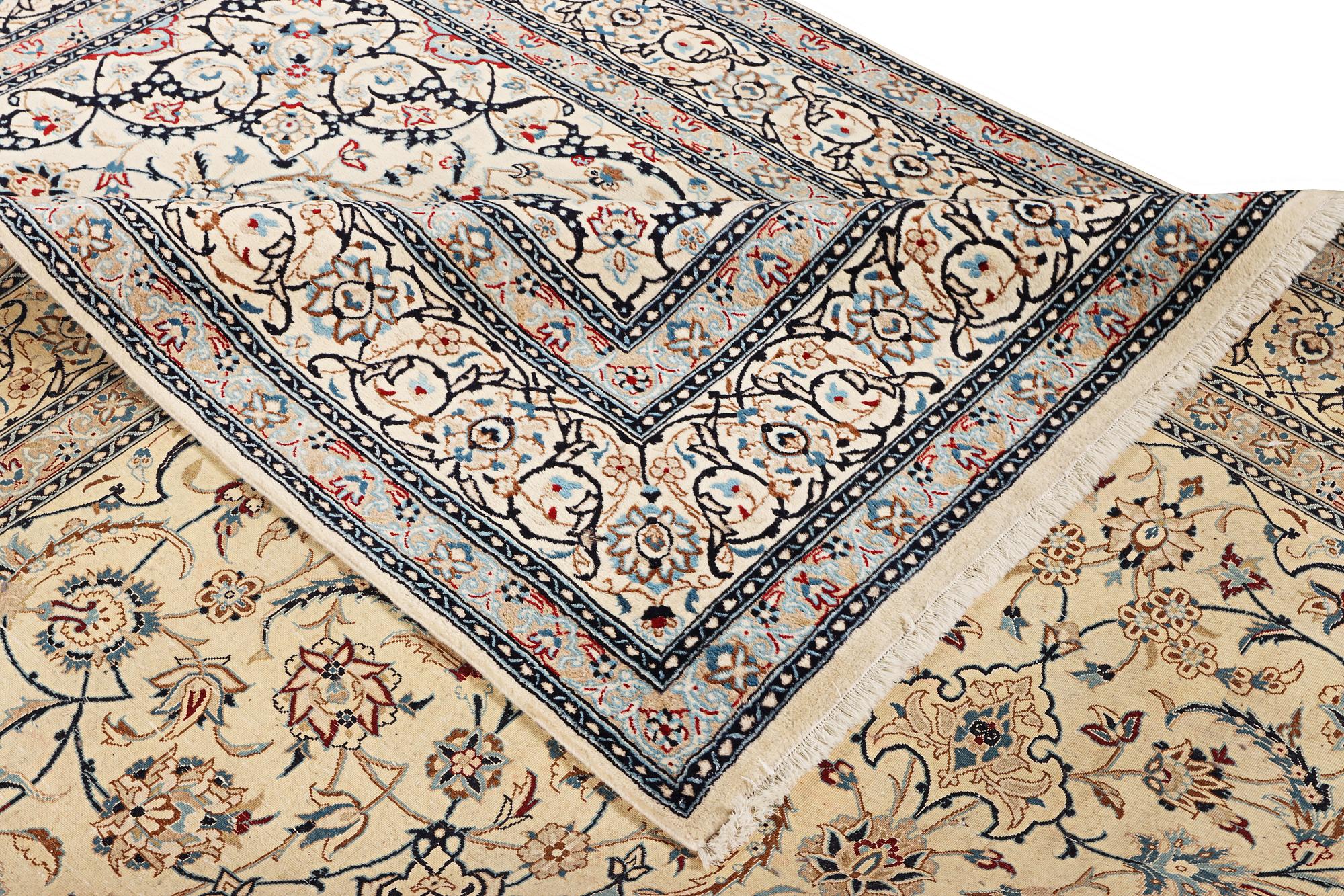 A Nain carpet, part silk, 9 laa, c. 390 x 295 cm.