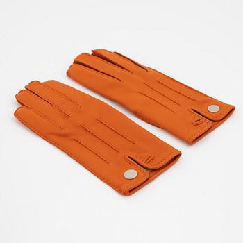 Hermès, a pair of orange kidskin and lambskin gloves, french size 7 1/2.