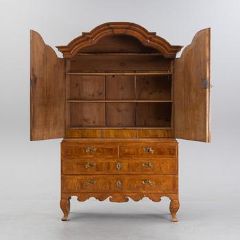 A walnut-veneered rococo cabinet in the manner of C. Linning, later part of the 18th Century.