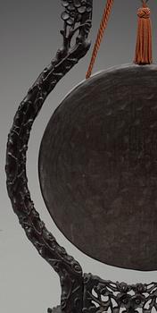 A bronze gong with a wooden stand, Qing dynasty.