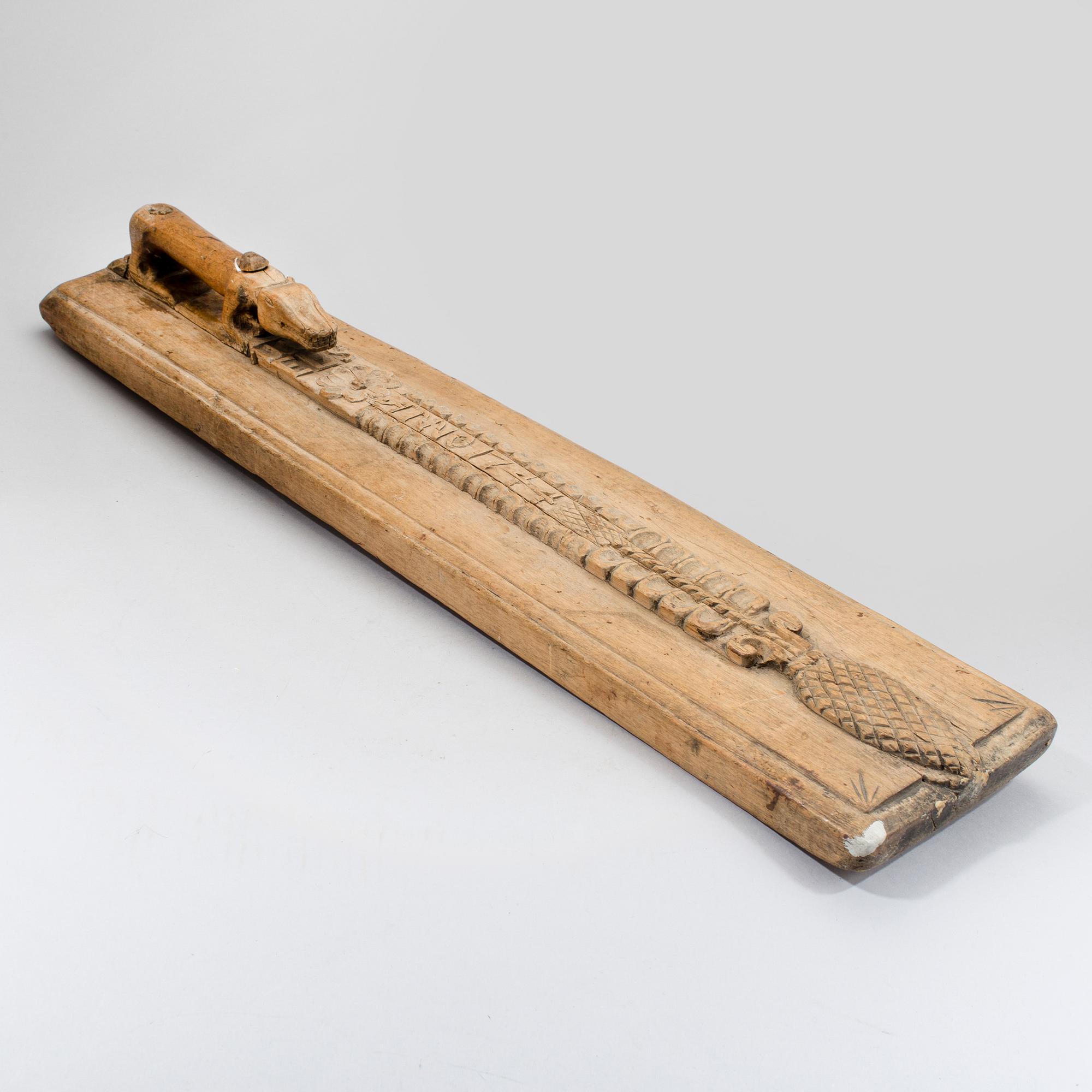 A Swedish folk art mangle board with carved decorationd, owners' initials and the date 1744.