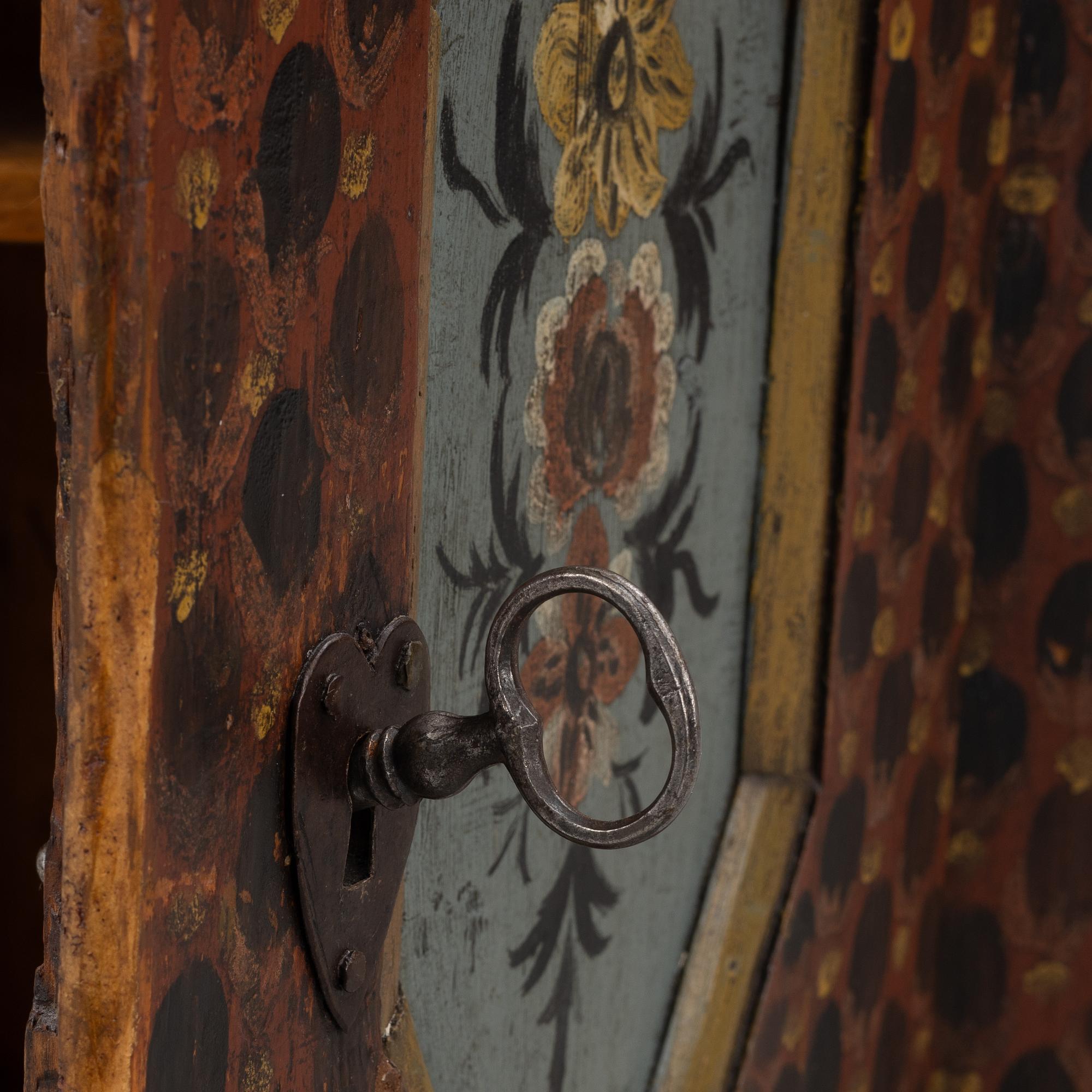 A painted wall cabinet, dated 1817.