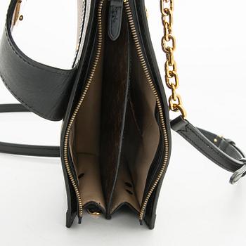 Louis Vuitton, a "Reverse Monogram Trunk Clutch" bag.