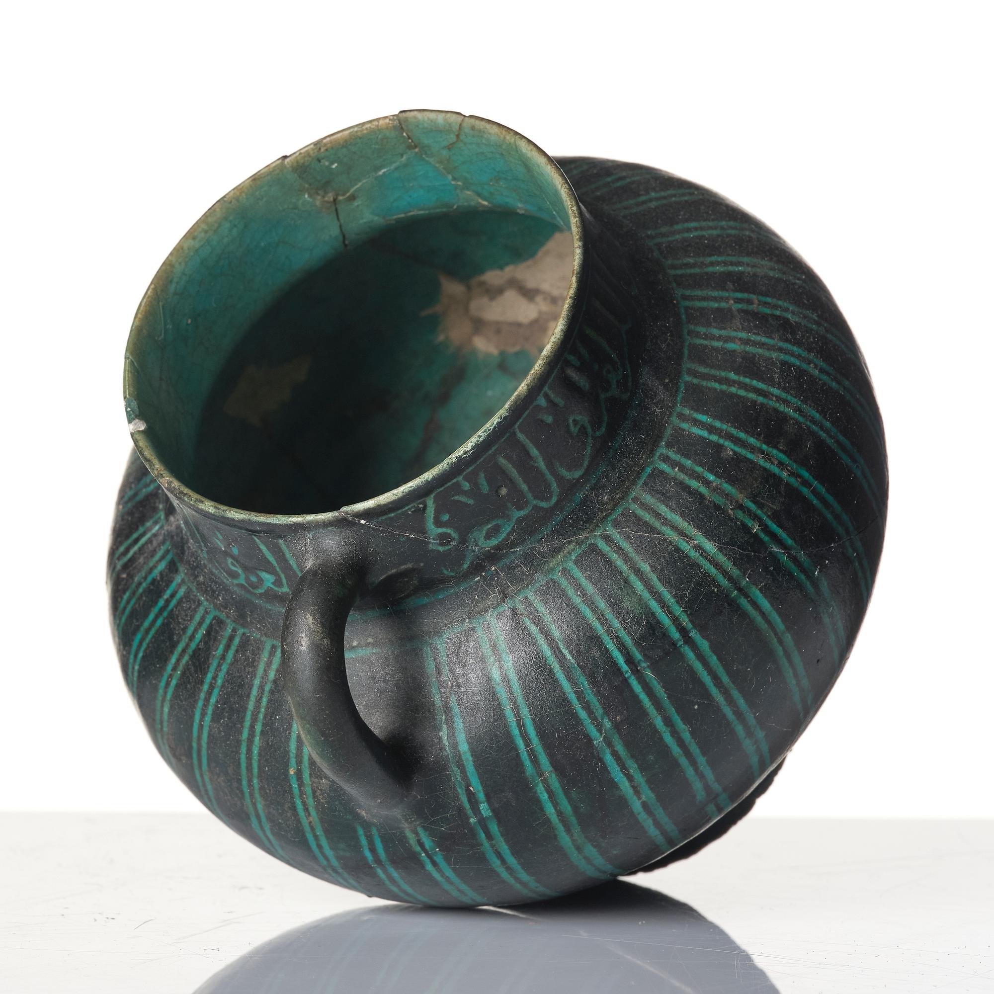 A Kashan Silhouette ware turquoise glazed pottery jug, central Iran, circa 1200.