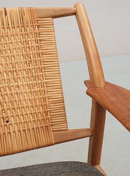 A pair of Danish teak and ratten armchairs, attributed, 1950's-60's.