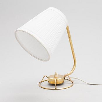 A mid-20th-century table lamp
/wall light for Idman.