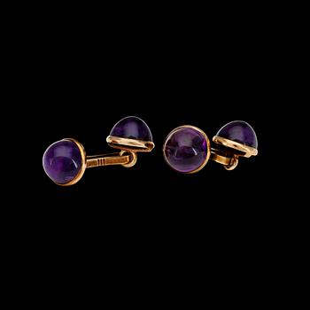 1090. A pair of German cabochon amethyst cufflinks.