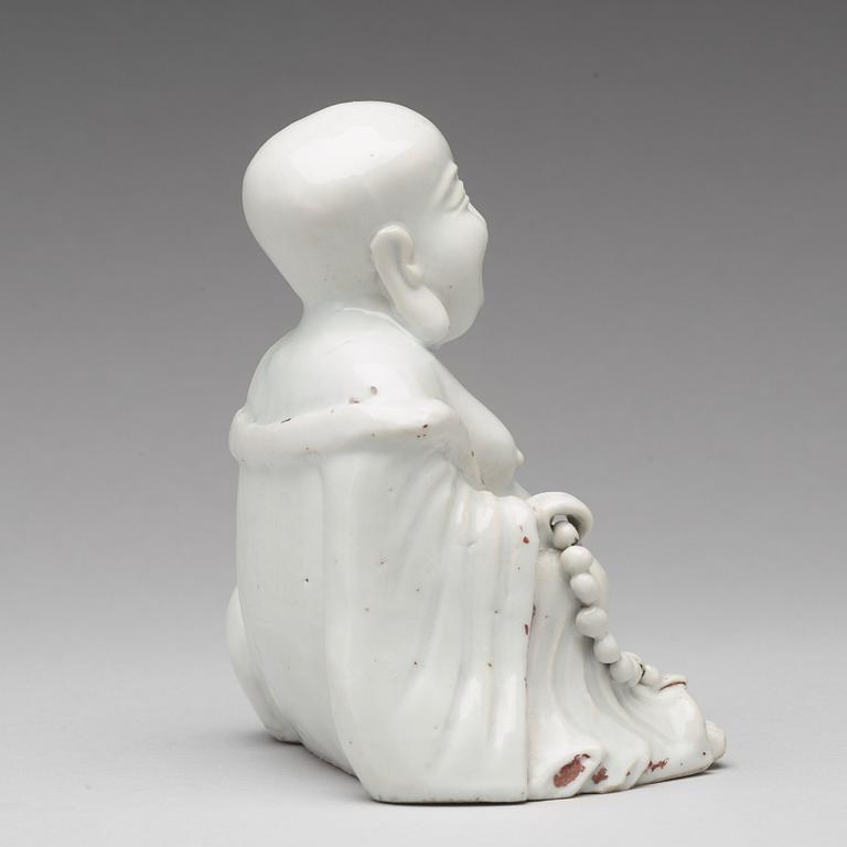 A blanc de chine figure of Buddai, Qing dynasty, 18th Century.