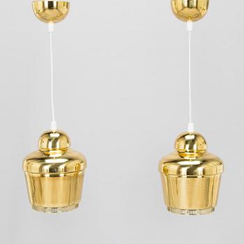 Alvar Aalto, A pair of  A 330, 'Golden Bell' pendant lights A330 for Artek, 2000s.