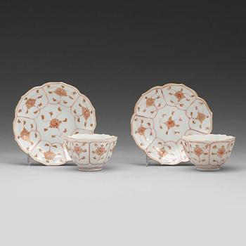 186. A pair of 'rouge de fer and gold' cups with stands, Qing dynasty, Qianlong (1736-95).