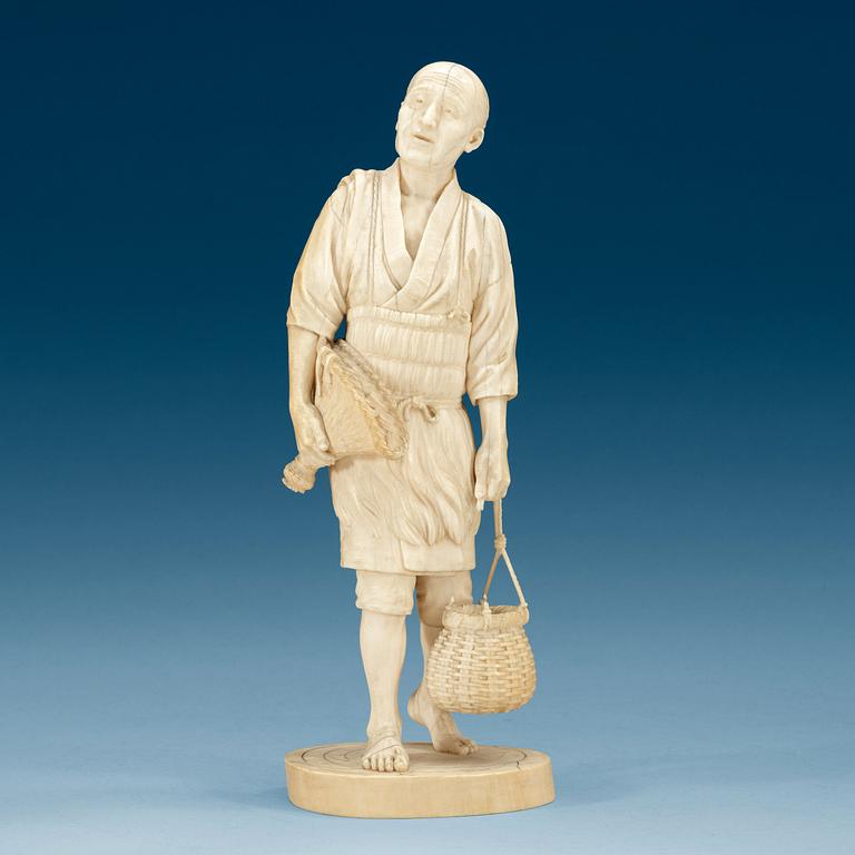 A Japanese ivory figure of a fisherman, Meiji (1868-1912).