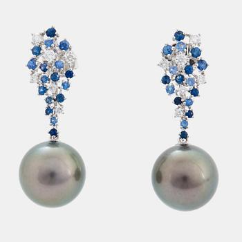 A pair of 18K white gold earrings set with Tahitian cultured pearls and round brilliant-cut diamonds.