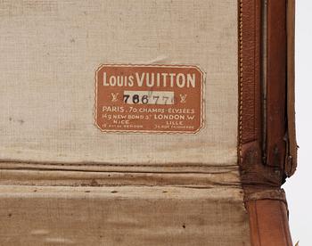 A late 19th cent leather suitcase by Louis Vuitton.