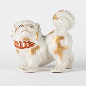 A Japanese Hirado ware style okimono in the shape of a dog, 20th Century.