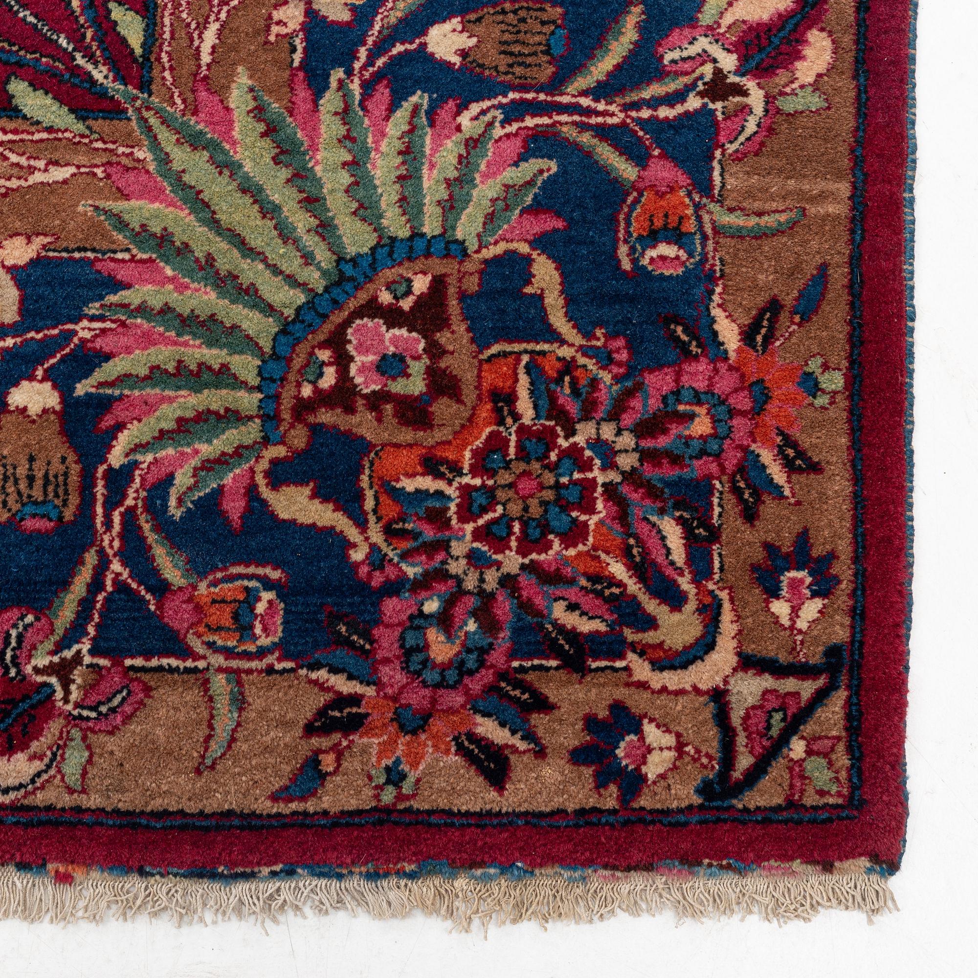 A semi-antique Mashad carpet, northeastern Persia, c. 404 x 307 cm.