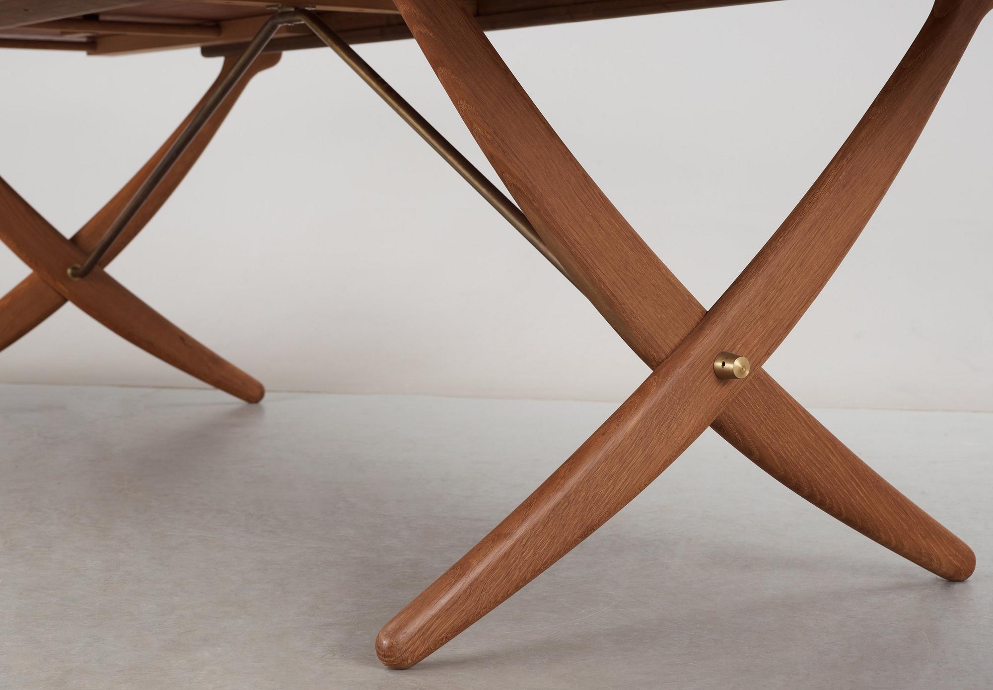 A Hans J Wegner teak and oak sabre leg dinner table by Andreas Tuck, Denmark 1950-60's.