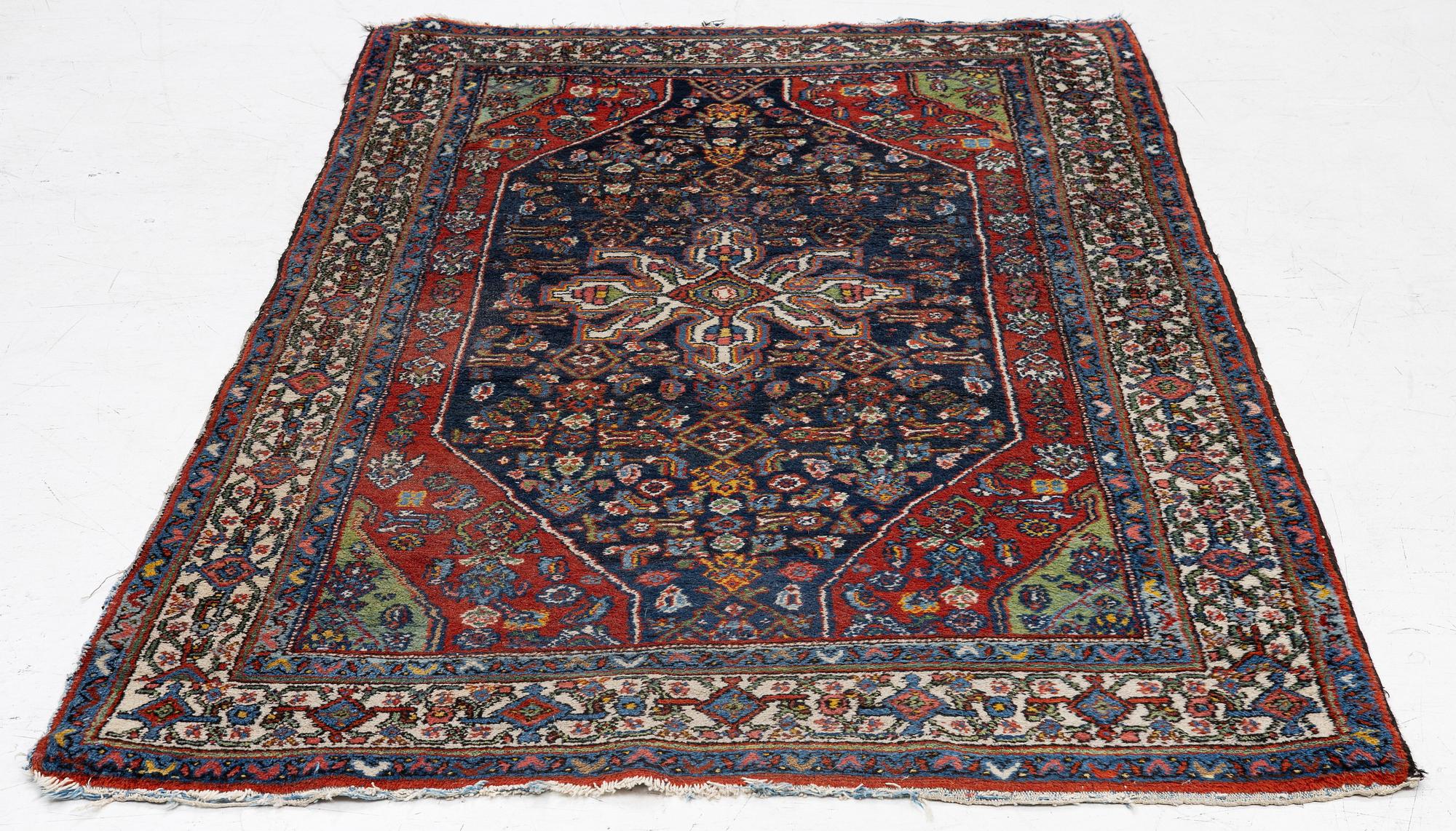 An oriental, semi-antique rug, c. 195 x 130 cm.