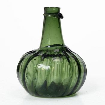 A green twisted glass bottle, 18th century.