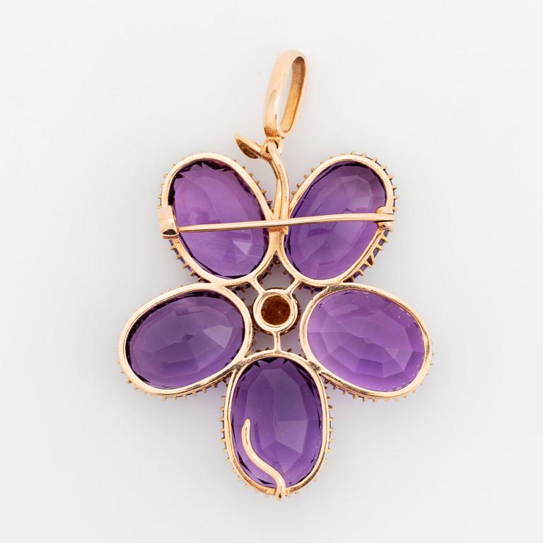 An 18K gold brooch/pendant set with faceted amethysts and a pearl.