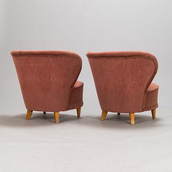 A pair of 1950s armchairs.