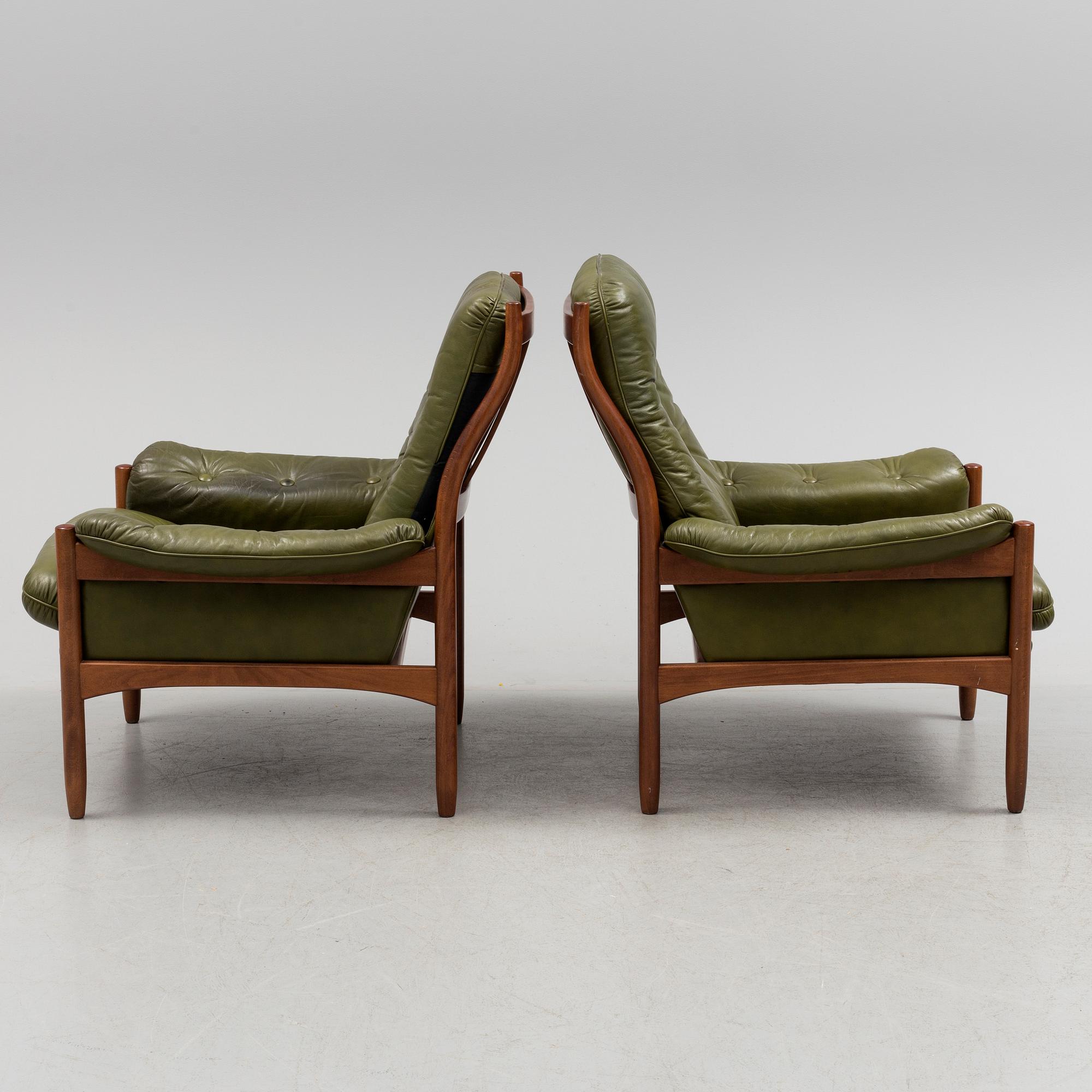 A pair of stained beech and leather easy chairs from Göte Möbler, Nässjö, second half of the 20th century.
