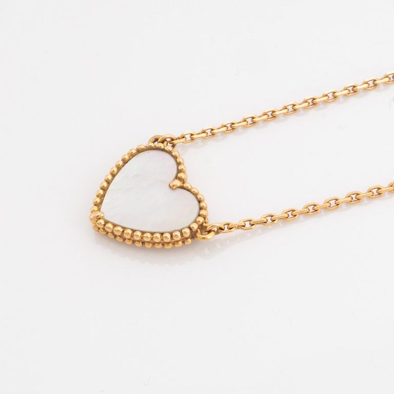 Van Cleef & Arpels, 18K gold and mother of pearl Alhambra heart necklace.