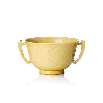 1245. An imperial yellow glazed two handled wine cup, Qing dynasty, Kangxi mark and of the period (1662-1722).