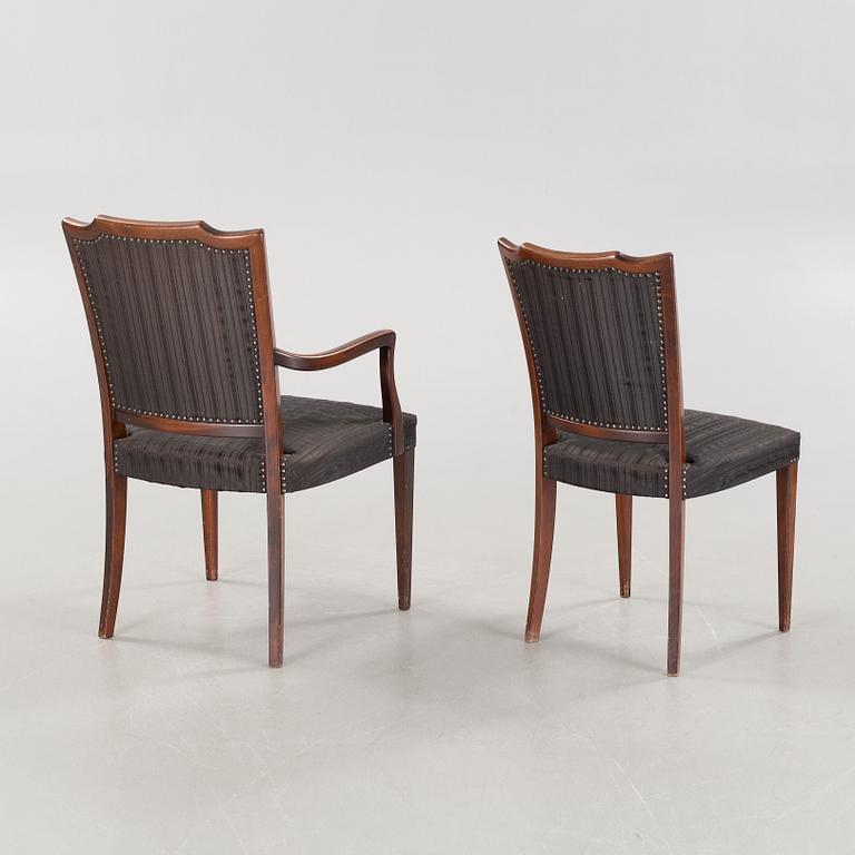 An english style dining table and eight chairs, second half of the 20th century.