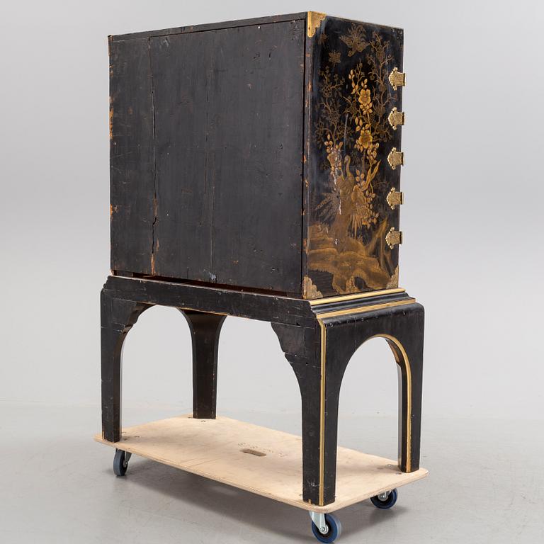 AN early 18TH CENTURY PROBABLY ENGLISH Japanned laquer cabinet on stand.