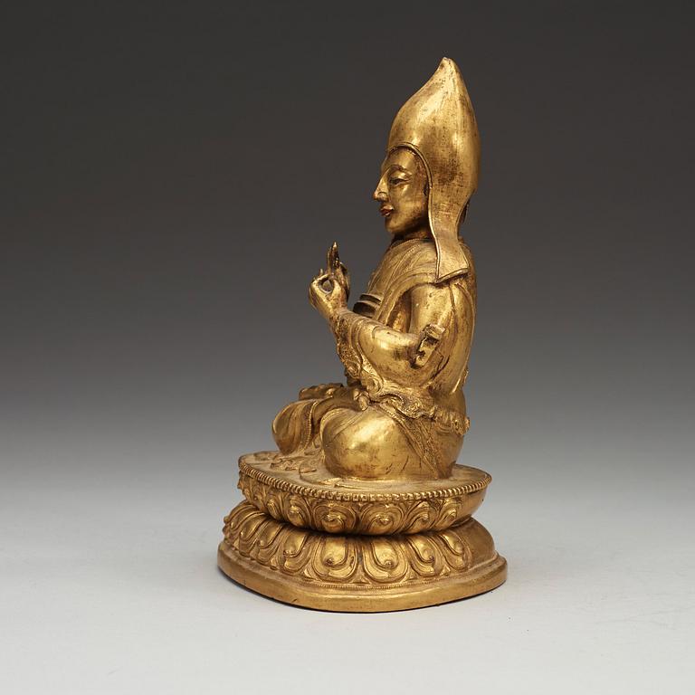 A Sino-Tibetan gilt copper alloy repoussé figure of Tsong Khapa, 18/19th Century.