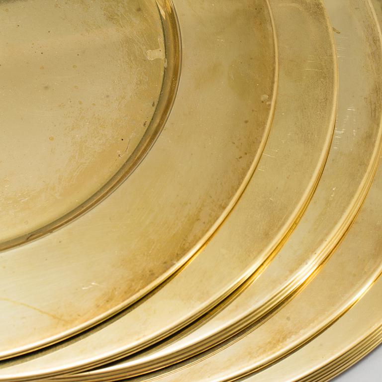 21 BRASS UNDER PLATES, second half of the 20th century.