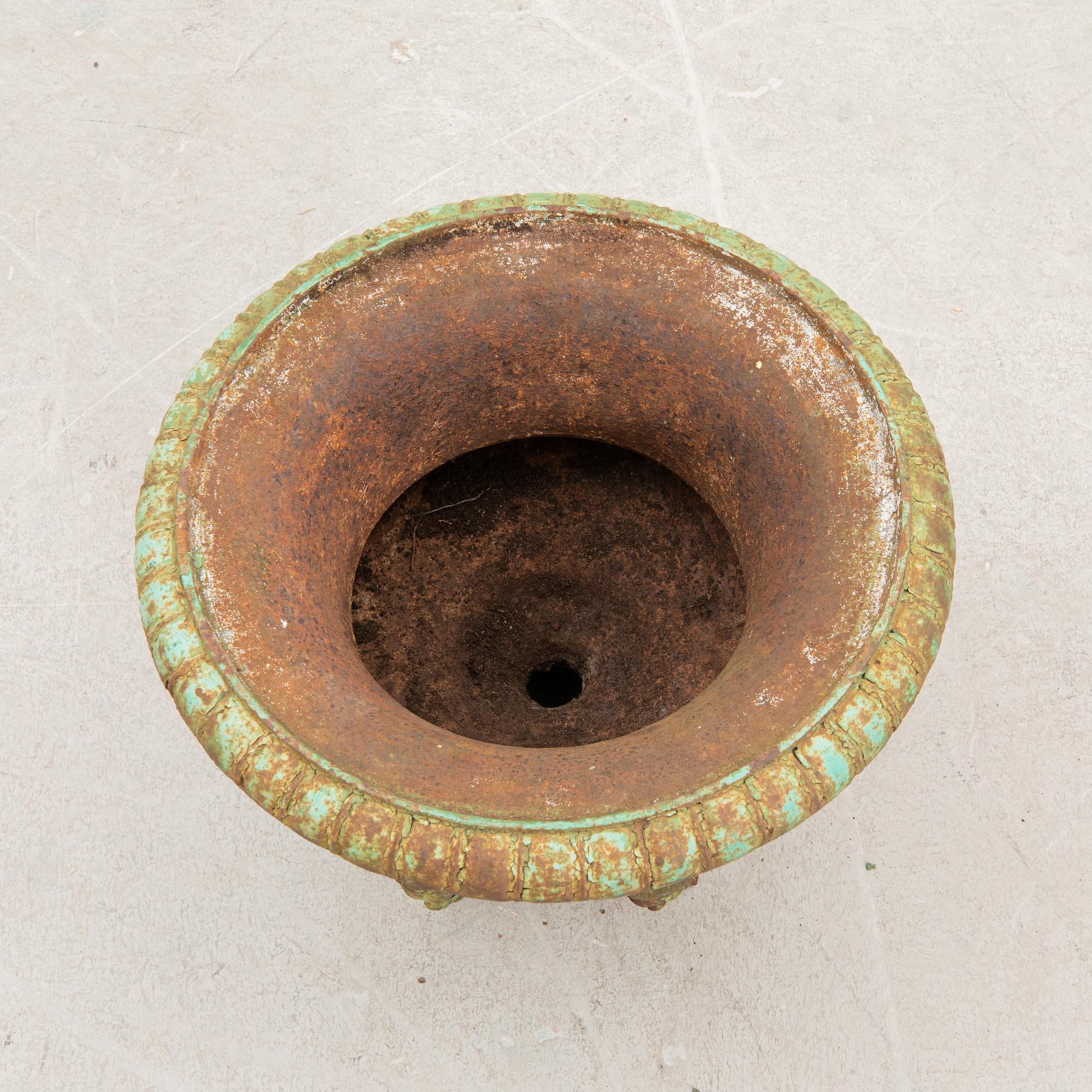 A cast iron garden urn around 1900.