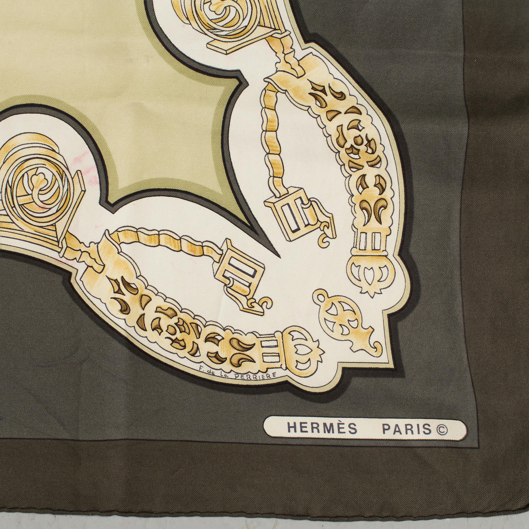 A "Les Eperons" silk scarf by Hermès.