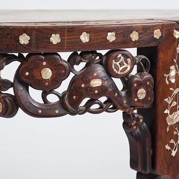 A Chinese hardwood demi-lune side table with mother-of-pearl inlays, late Qing dynasty.