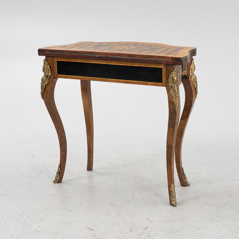 A Louis XV-style games table, early 20th century.