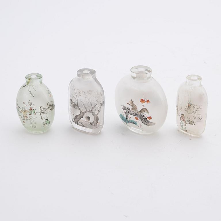 Four Chinese glass snuff bottles and one blue monochrome porcelain bowl, 20th century and modern manufacturing.