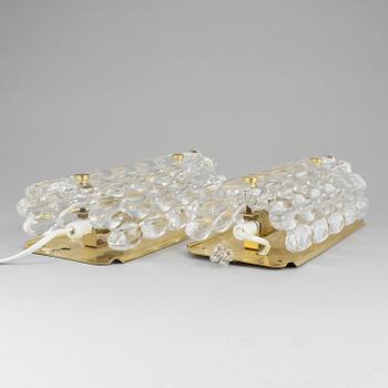 A pair of brass and glass wall lights designed by Carl Fagerlund for Orrefors.