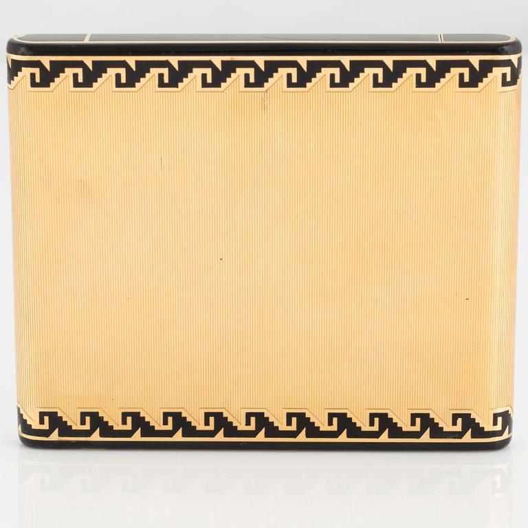 A Cartier Art Deco cigarett case in 18K gold with black enamel.