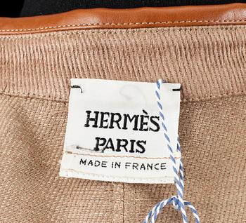 A beige linen jacket by Hermès.