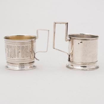 Two tea glass holders in silver, one with mark of Ivan Saltykov, Moscow 1889, the other one marked Moscow 1908-1917.