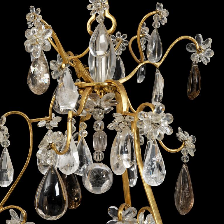 A near pair of Franch Louis-XV-style nine-branch gilt bronze and rock crystal chandeliers, later part 19th century.