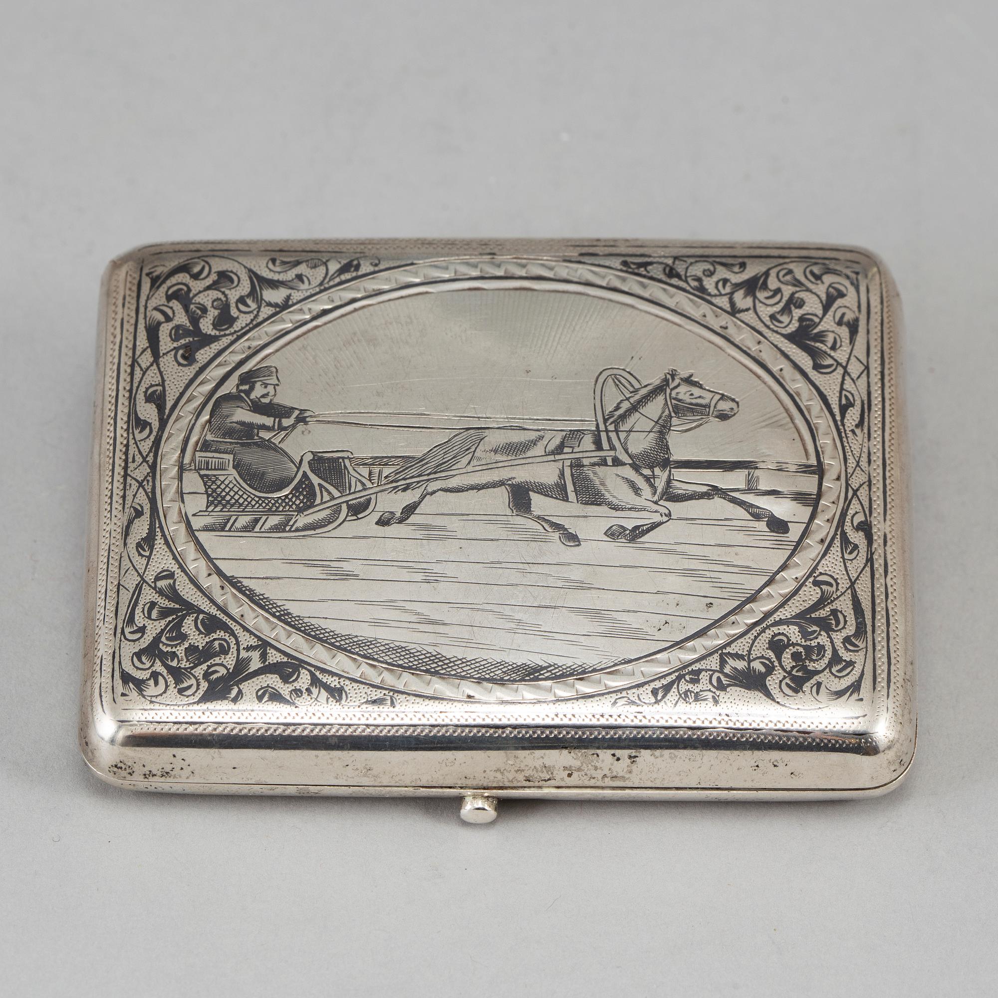 A Russian parcel-gilt silver and niello cigarette-case, import marks 1882-98.