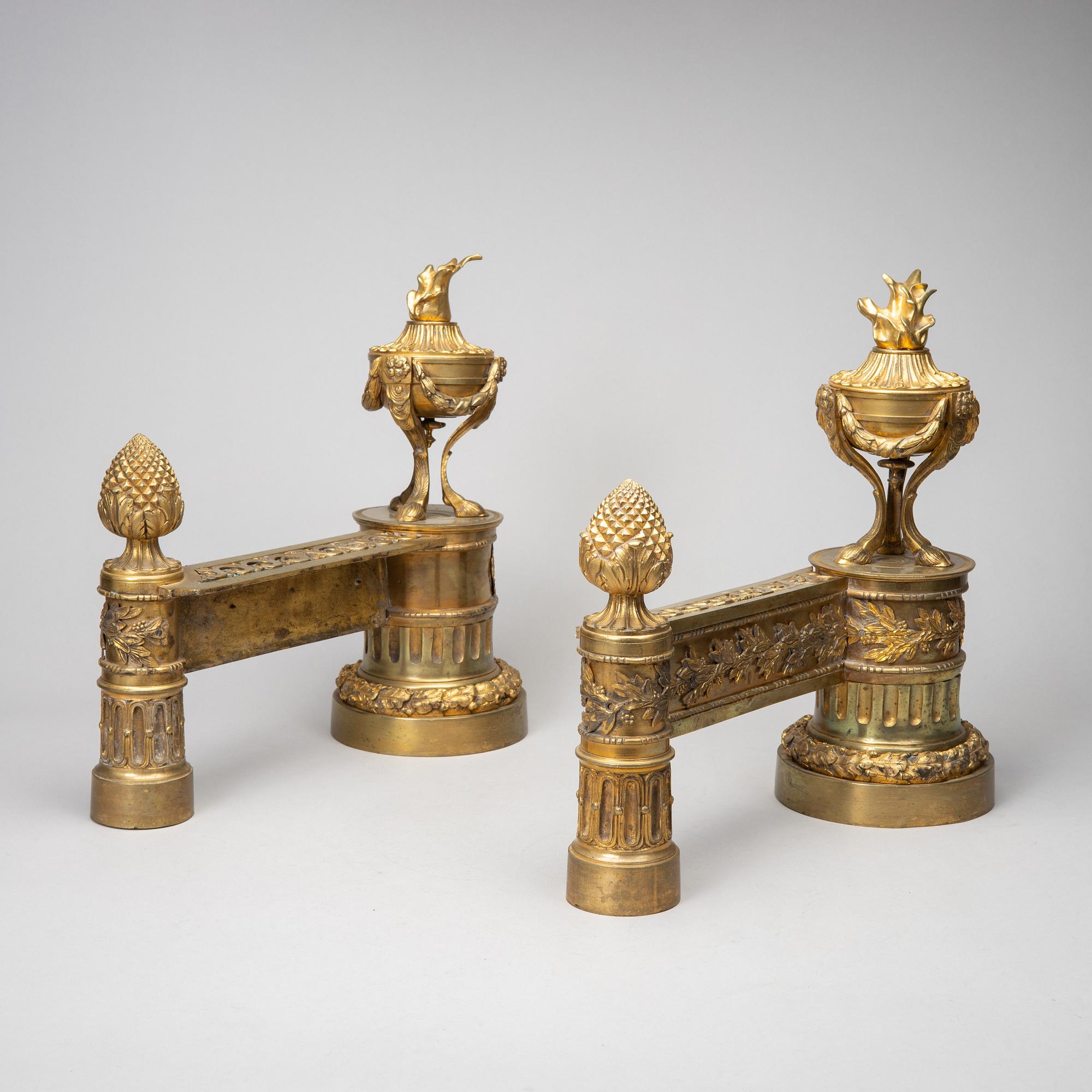 A pair of gilt brass Louis-XVI style andirons, second half of the 19th Century.