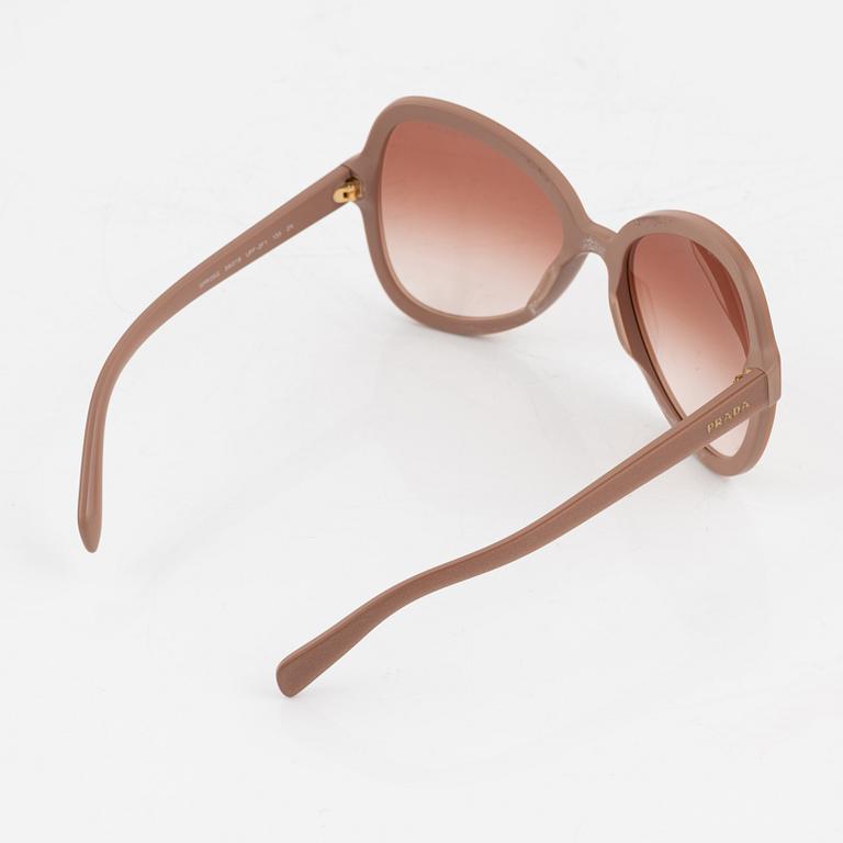 Prada, a pair of coral pink color sunglasses.