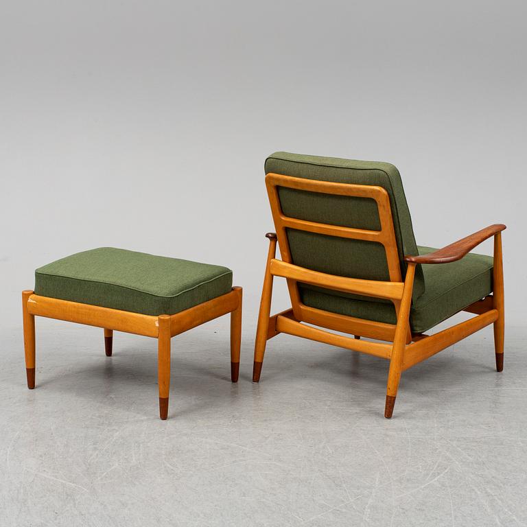 A 1950's beech and teak model FD 161 easy chair with stool by Arne Vodder for France & Son.