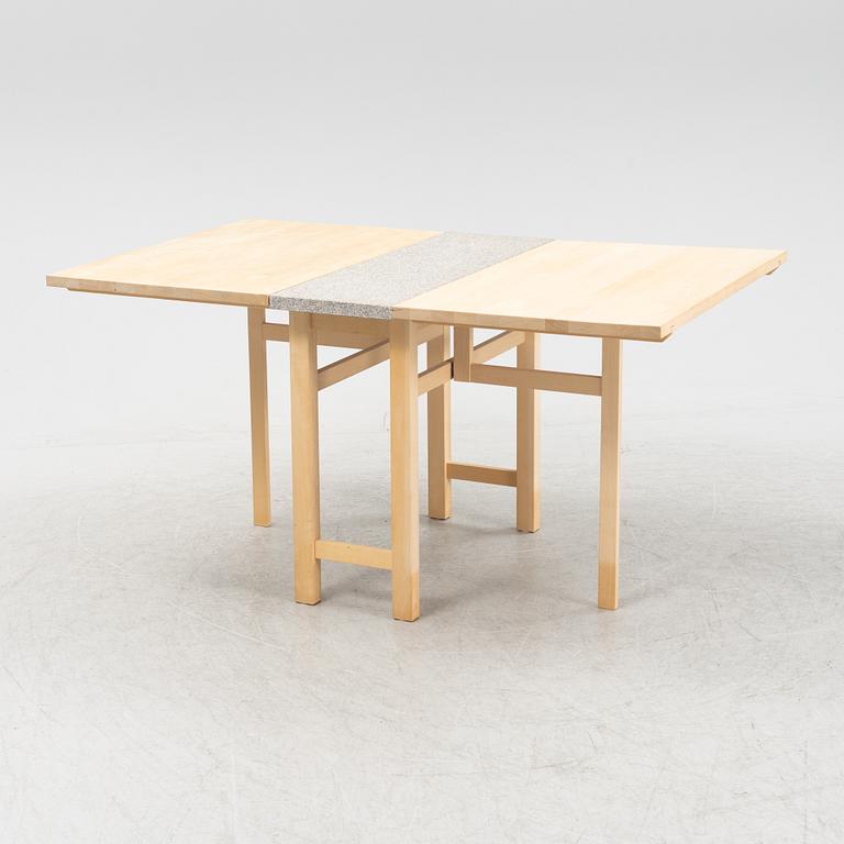 A birch gate leg table with a stone top by Marit Stigsdotter for Stolab, dated 2002.