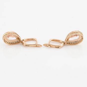 A pair of 18K gold earrings with faceted morganites and round brilliant-cut diamonds.