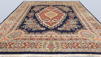 A semi-antique Kirman Laver carpet, 'Millefleur', signed, approx. 427 x 309 cm.