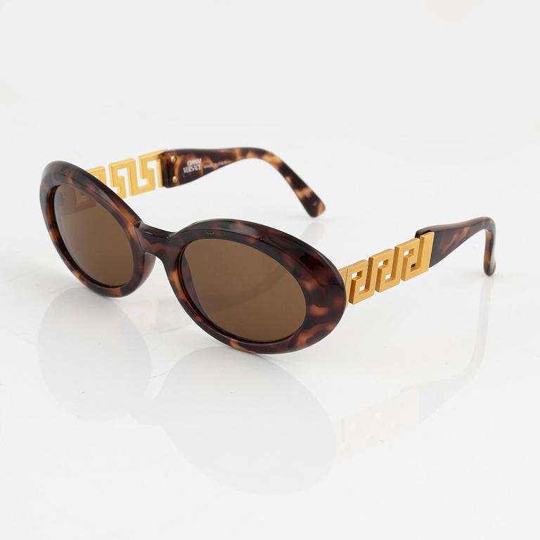 Gianni Versace, a pair of brown and gold sunglasses.